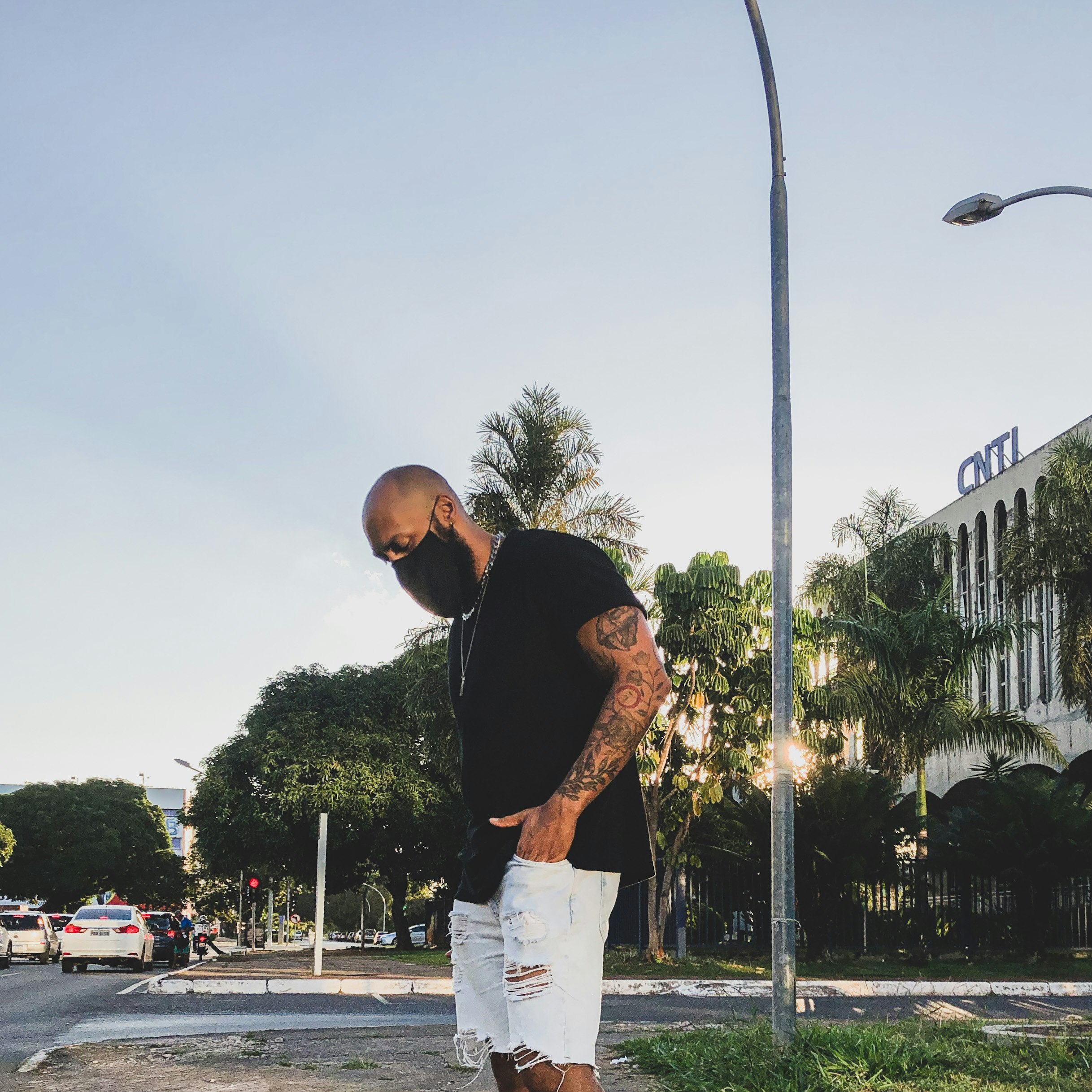 man in black t-shirt and white shorts standing on basketball court during daytime